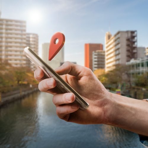 Joyful woman in stylish jumpsuit jumping on pink background, holding like sign