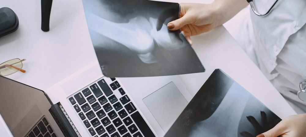 Smiling medical doctor woman with stethoscope. Isolated over white background. Image of an enthusiastic intern looking at camera