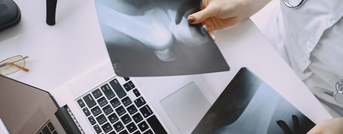 Smiling medical doctor woman with stethoscope. Isolated over white background. Image of an enthusiastic intern looking at camera
